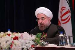 Families of nuclear martyrs accompany President Rouhani in press conference 